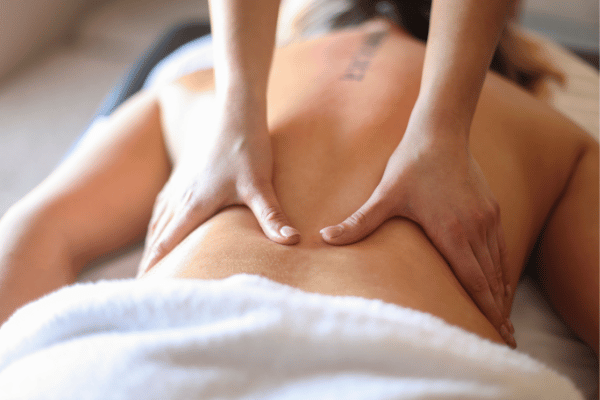 A woman experiencing a calming back massage
