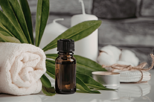 A collection of essential oils arranged for skin care, showcasing various bottles and natural ingredients.